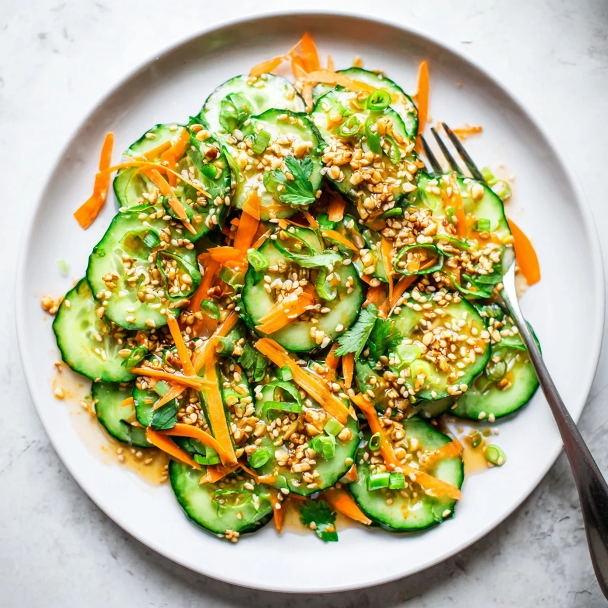 Refreshing Asian cucumber salad featuring crunchy vegetables coated in savory ginger garlic dressing