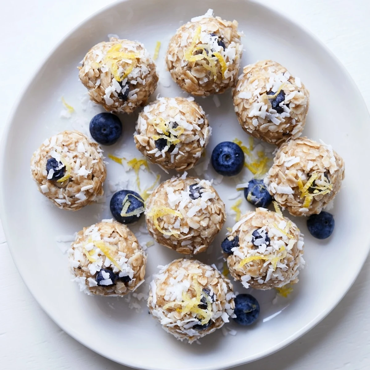 Creamy cottage cheese protein bites studded with juicy blueberries and bright lemon zest on wooden board