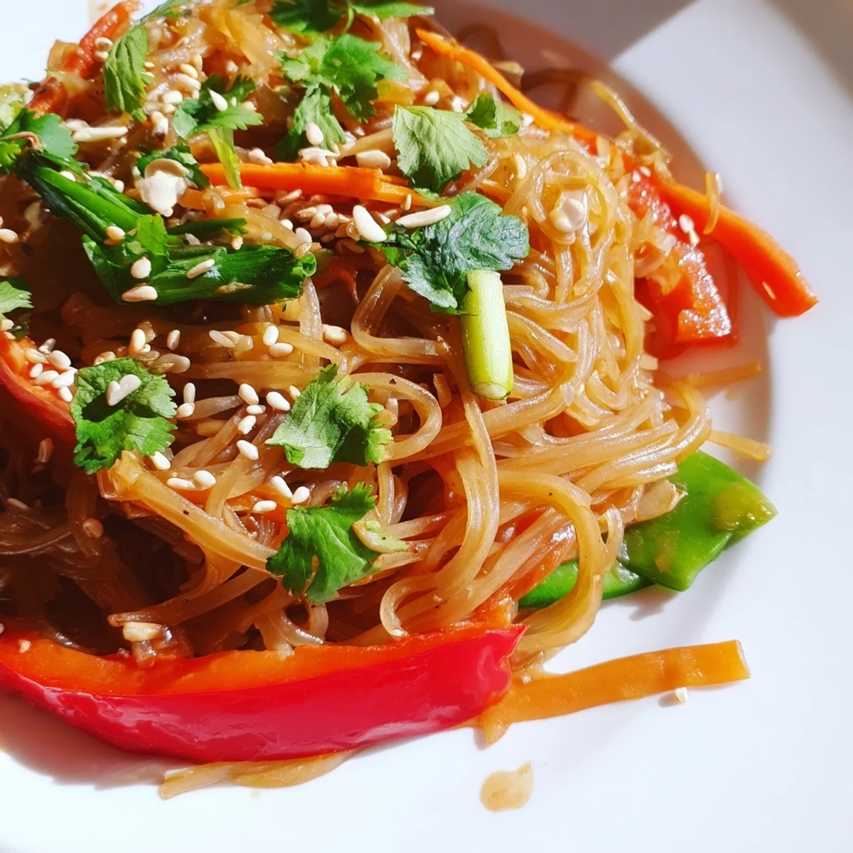 Colorful rice noodle stir fry with crisp vegetables in a savory sauce