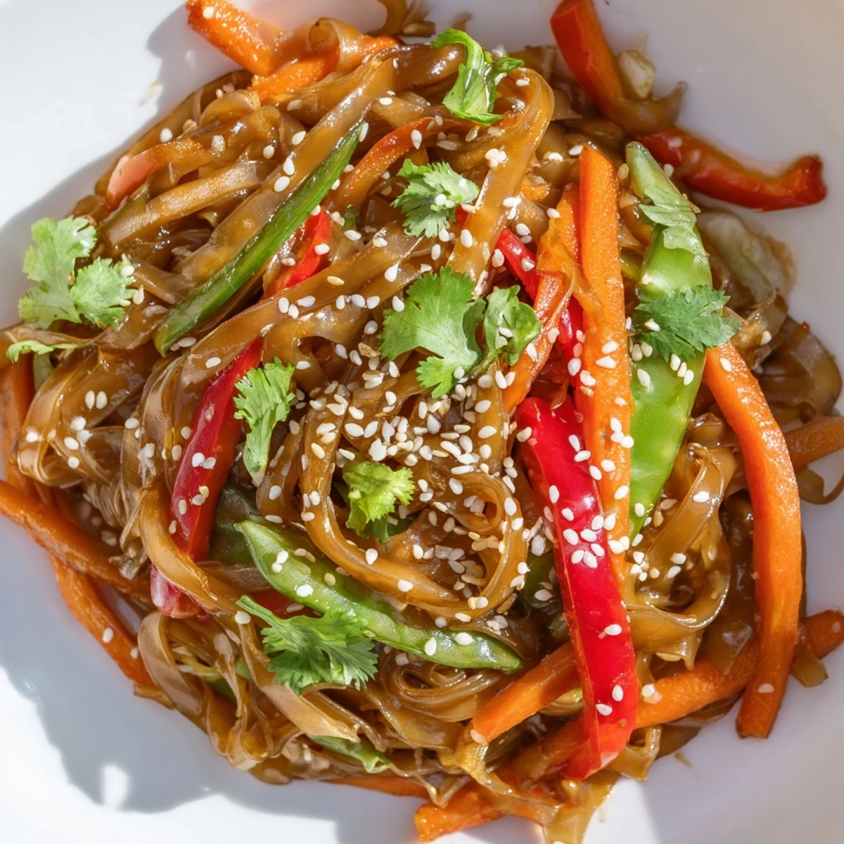 Sizzling rice noodle stir fry tossed with snap peas and bell peppers