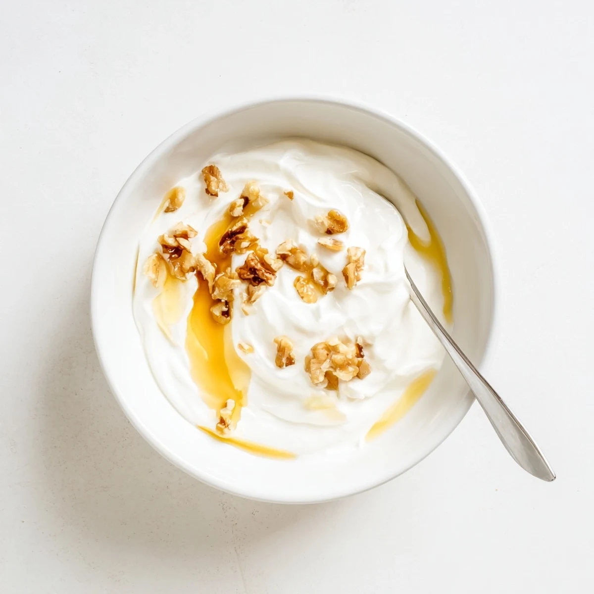 Thick creamy Greek yogurt bowl topped with fresh berries and honey for breakfast