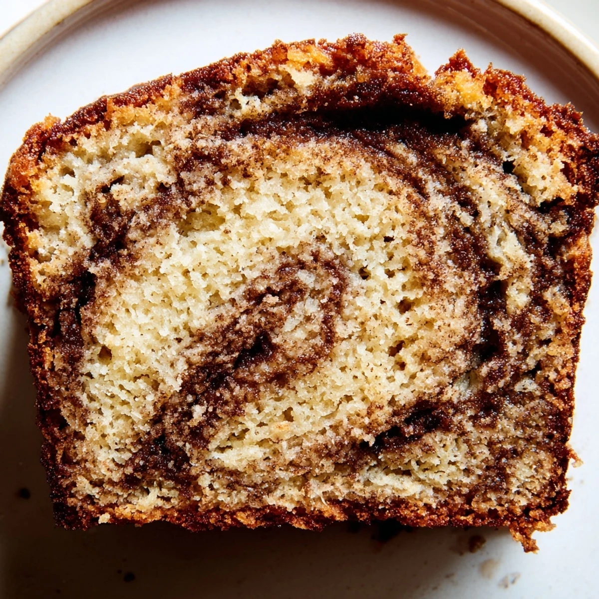 Golden Cinnamon Sugar Swirl Banana Bread slice revealing moist tender crumb with spiced marbled ribbon throughout