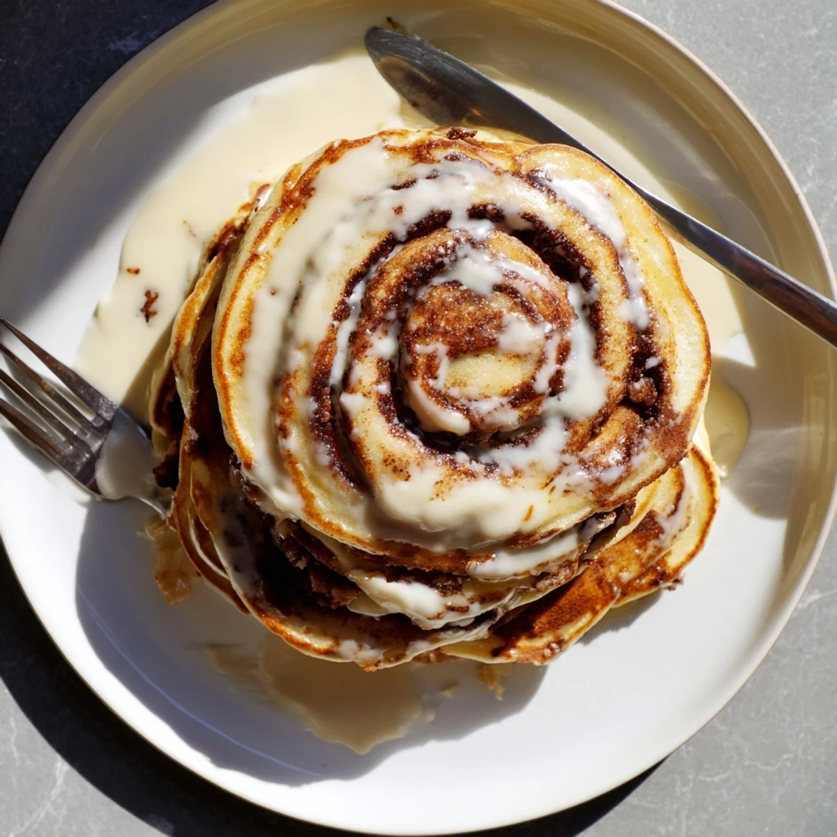 Fluffy pancakes swirled with warm cinnamon sugar and topped with sweet glaze