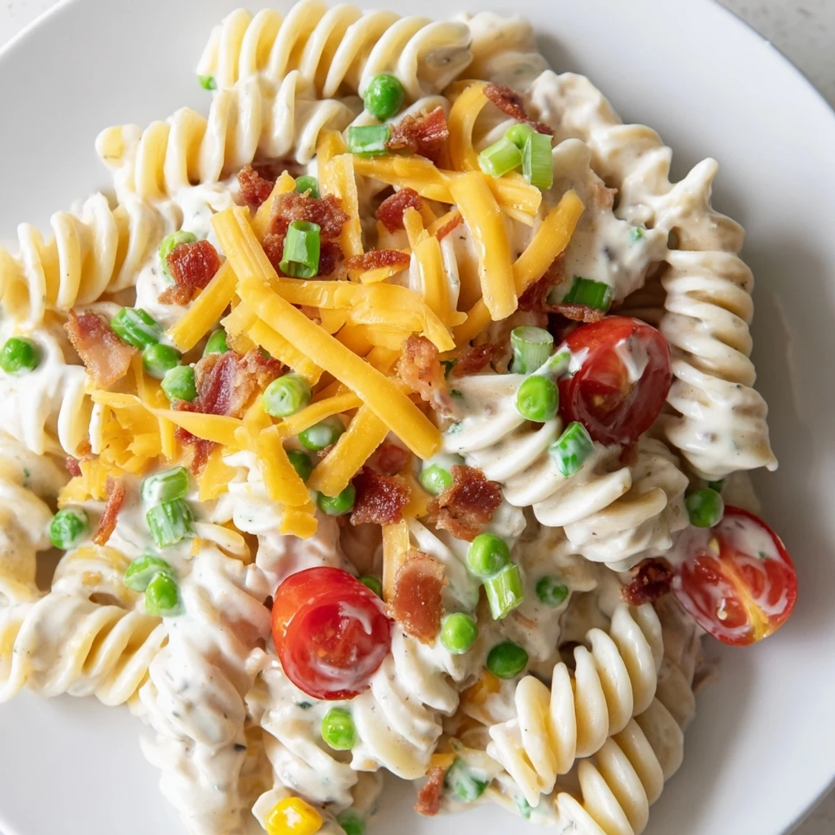 Colorful crack pasta salad in a bowl with cherry tomatoes and ranch dressing