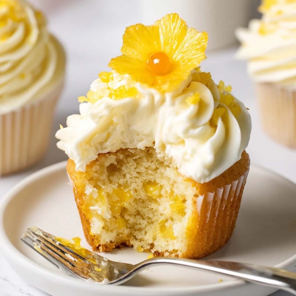 Slice reveals moist crumb in Dole Whip Cupcakes Recipe, tangy pineapple notes