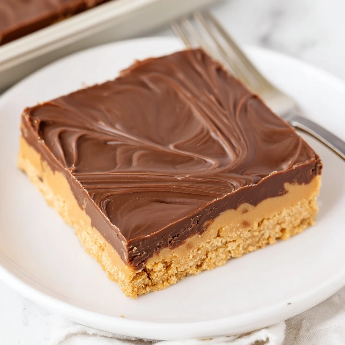 No Bake Peanut Butter Bars chilled, glossy chocolate topping, cut into squares