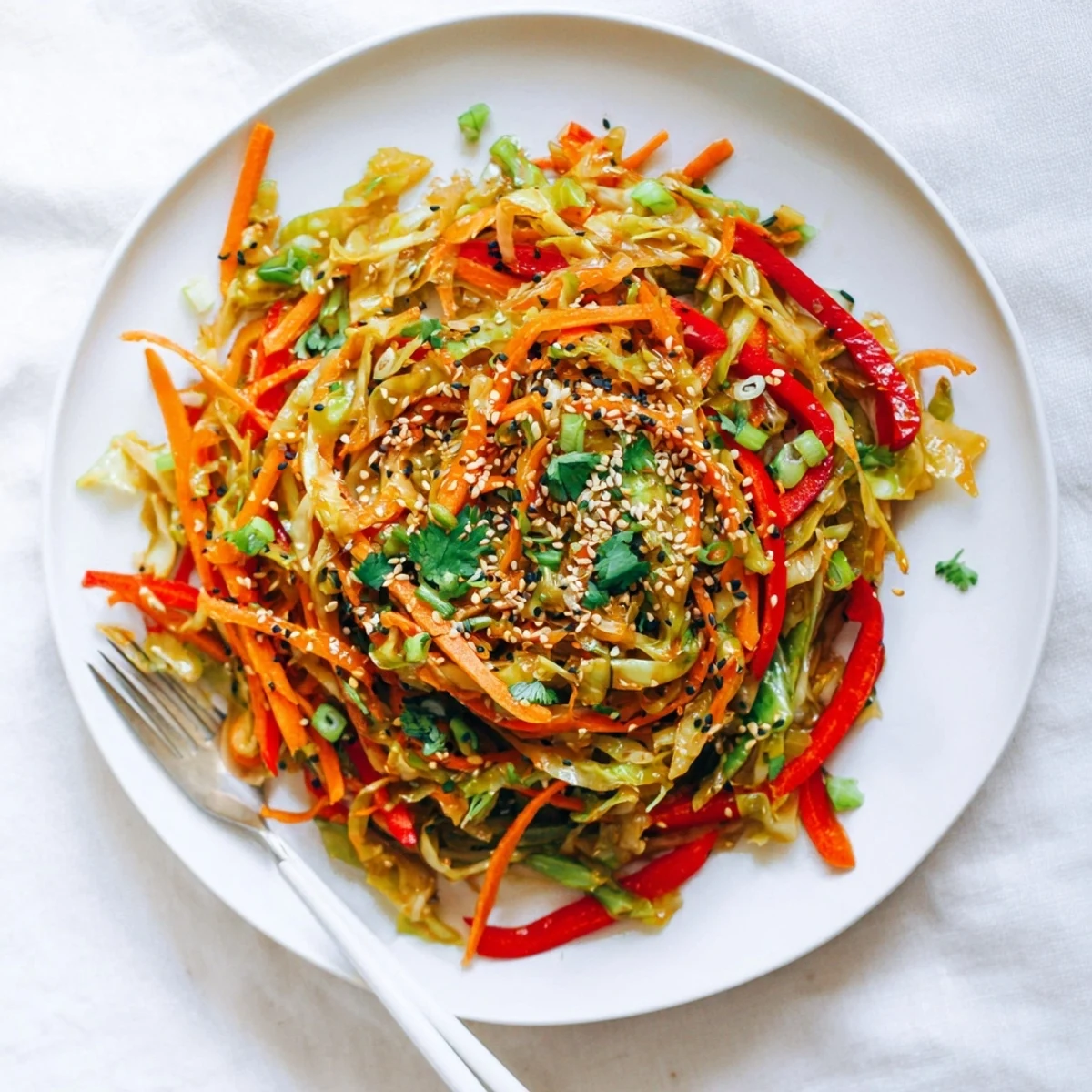 Colorful cabbage stir fry recipe with crisp vegetables and savory glossy sauce in a wok