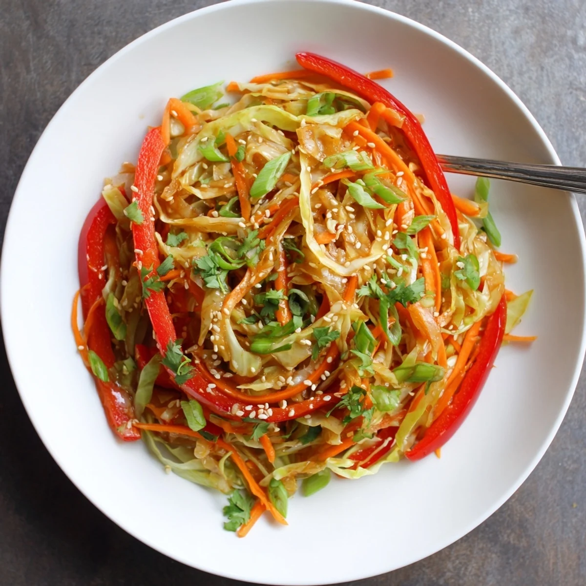 Quick cabbage stir fry recipe plated with tender crisp veggies and aromatic ginger garlic sauce