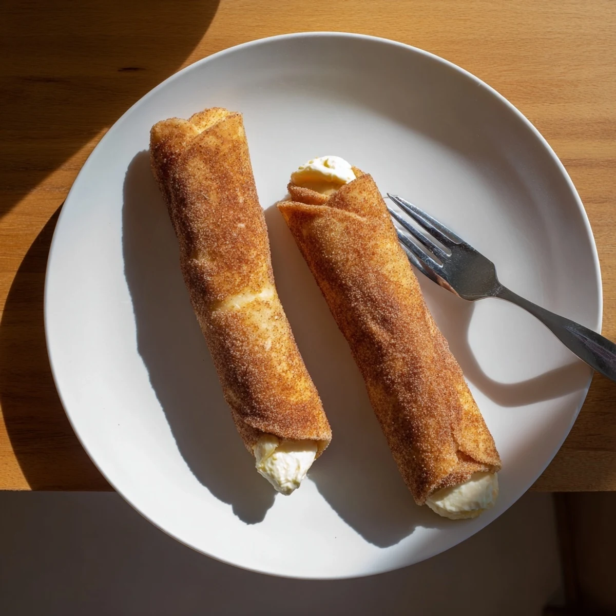 Creamy cheesecake chimichangas fresh from the fryer with a caramelized crunch