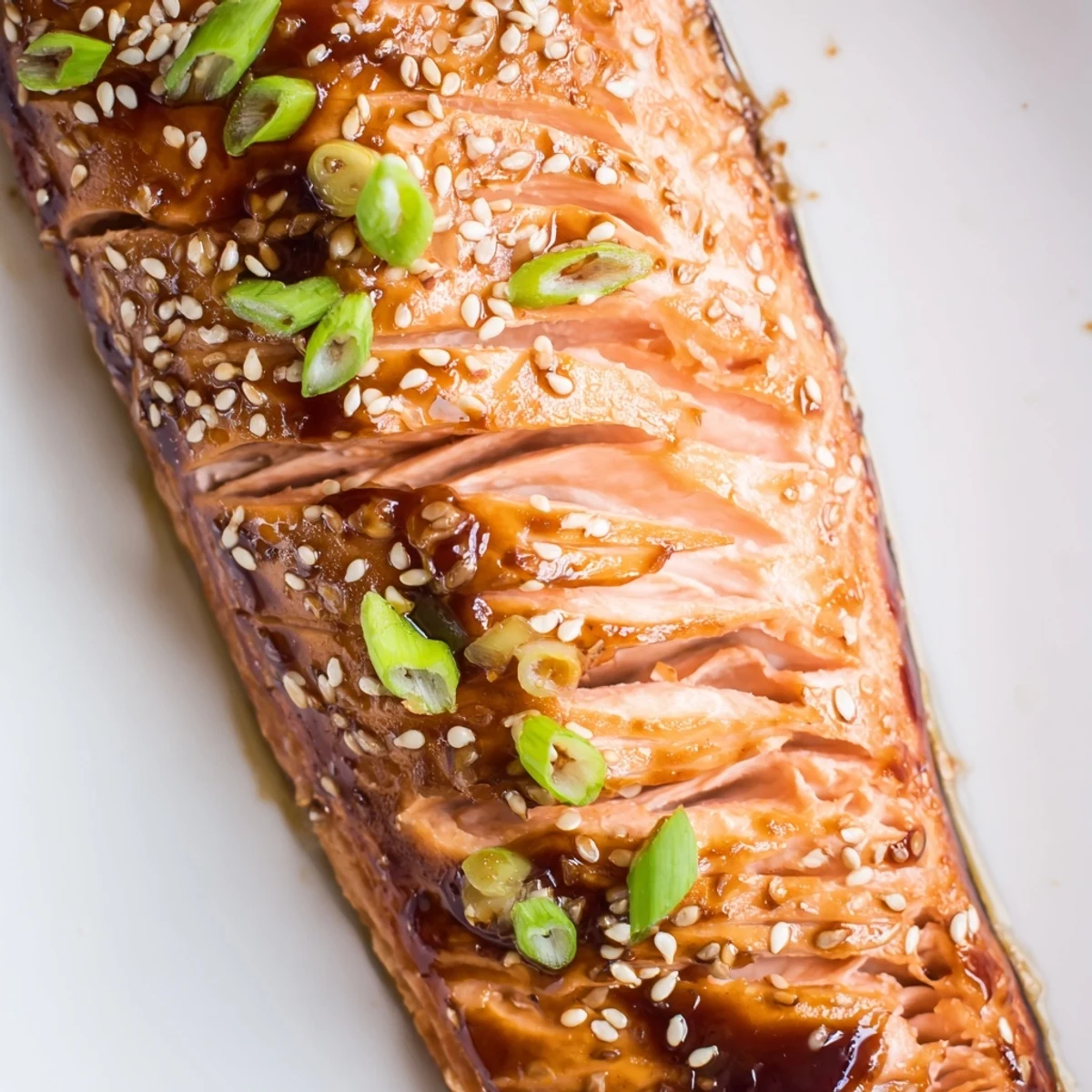 Tender baked Asian salmon on a parchment-lined pan ready for a weeknight dinner
