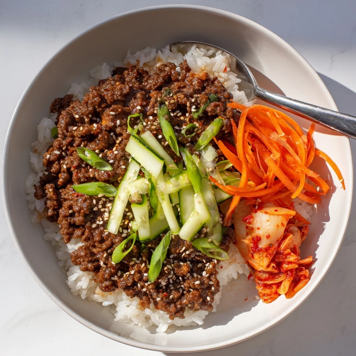 Korean ground beef bowl with glistening sauce, crisp veggies, and steamed rice